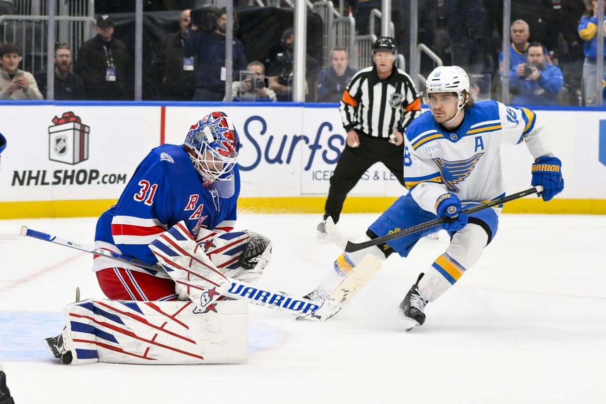 Dec 18, 2025; St. Louis, Missouri, USA; New York Rangers goaltender Igor Shesterkin (31) defends the net against St. Louis Blues center Robert Thomas (18) during overtime at Enterprise Center. Mandatory Credit: Jeff Curry-Imagn Images