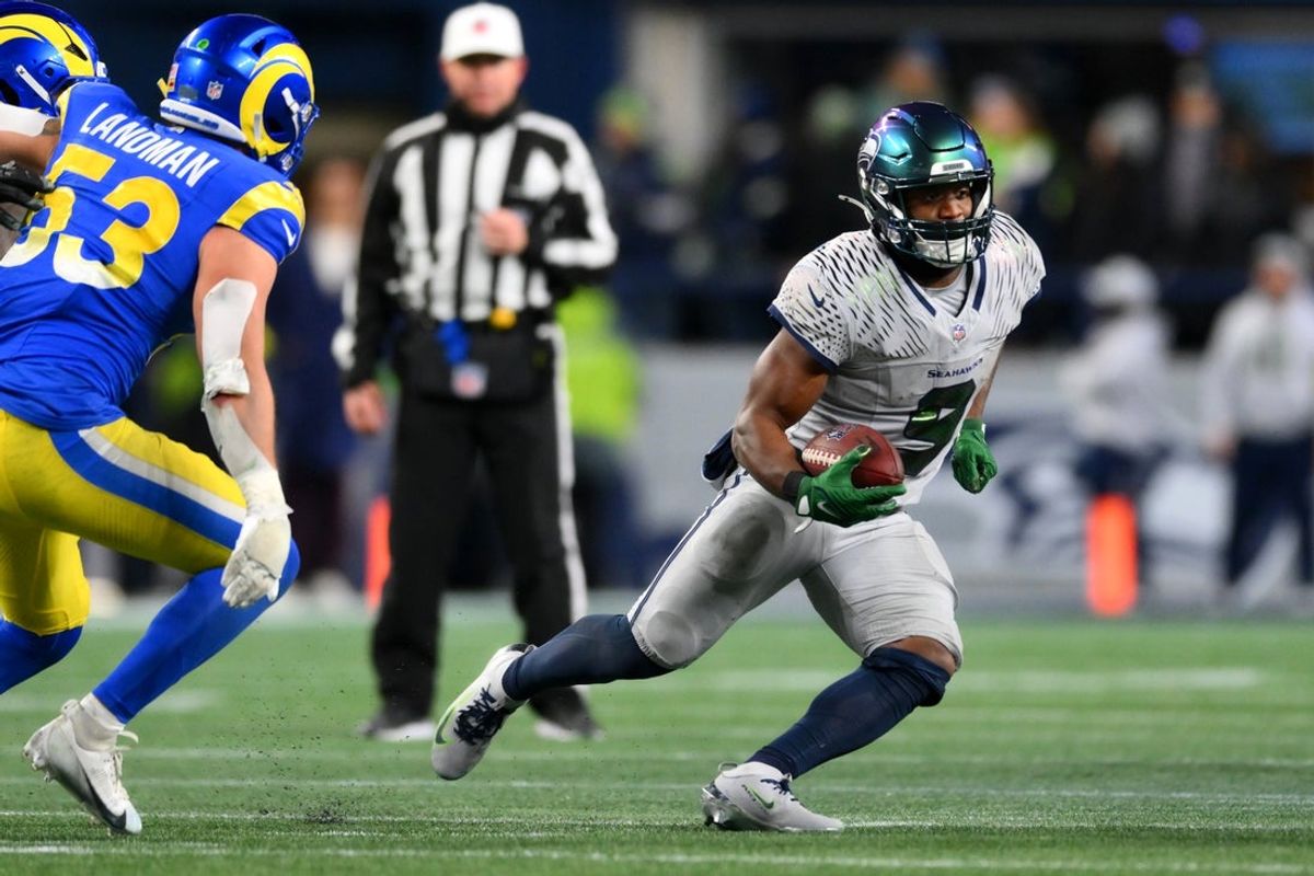 Dec 18, 2025; Seattle, Washington, USA; Seattle Seahawks running back Kenneth Walker III (9) runs against the Los Angeles Rams in overtime at Lumen Field. Mandatory Credit: Steven Bisig-Imagn Images