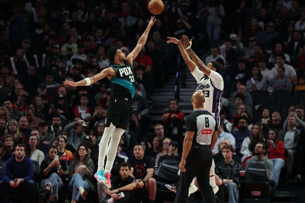Dec 18, 2025; Portland, Oregon, USA;  Portland Trail Blazers forward Toumani Camara (33) defends Sacramento Kings forward Keegan Murray (13) during the second half at Moda Center. Mandatory Credit: Jaime Valdez-Imagn Images