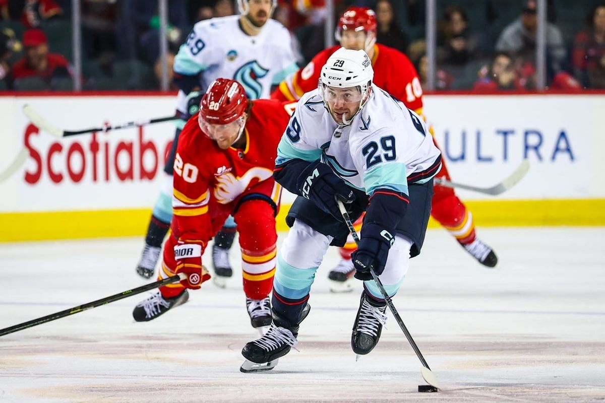 Dec 18, 2025; Calgary, Alberta, CAN; Seattle Kraken defenseman Vince Dunn (29) skates with the puck against the Calgary Flames during the third period at Scotiabank Saddledome. Mandatory Credit: Sergei Belski-Imagn Images