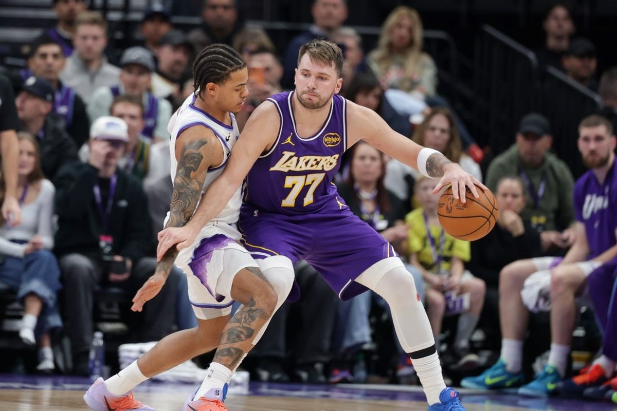 Dec 18, 2025; Salt Lake City, Utah, USA;  Los Angeles Lakers forward/guard Luka Doncic (77) tries to keep Utah Jazz guard Keyonte George (3) away from the ball during the second half at Delta Center. Mandatory Credit: Chris Nicoll-Imagn Images