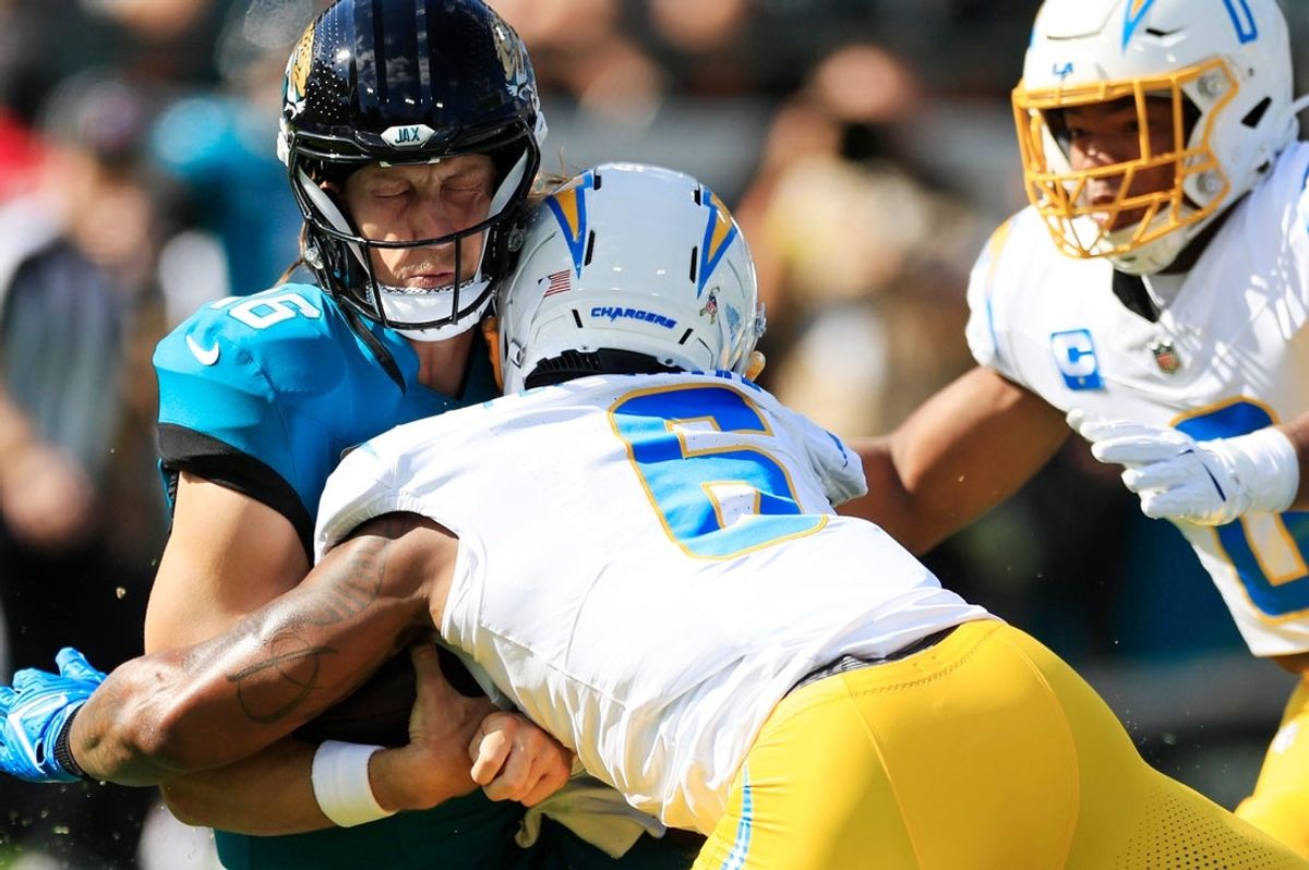 Jacksonville Jaguars quarterback Trevor Lawrence (16) slides down as no penalty is called on Los Angeles Chargers middle linebacker Denzel Perryman (6) during the first quarter of an NFL football game at EverBank Stadium, Sunday, Nov. 16, 2025 in Jacksonville, Fla. The Jacksonville Jaguars defeated the Los Angeles Chargers 35-6.