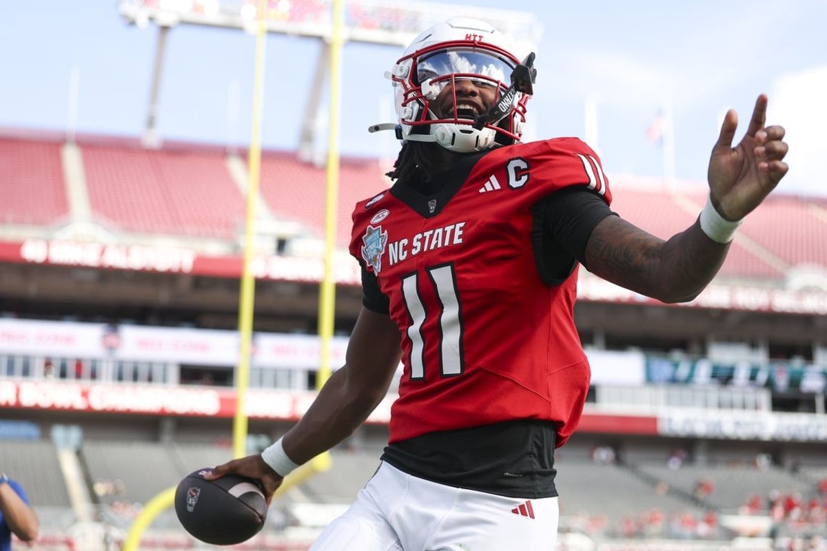 Dec 19, 2025; Tampa, FL, USA; NC State Wolfpack quarterback CJ Bailey (11) runs into the end zone for a touchdown against the Memphis Tigers in the first quarter during the Gasparilla Bowl at Raymond James Stadium. Mandatory Credit: Nathan Ray Seebeck-Image Images