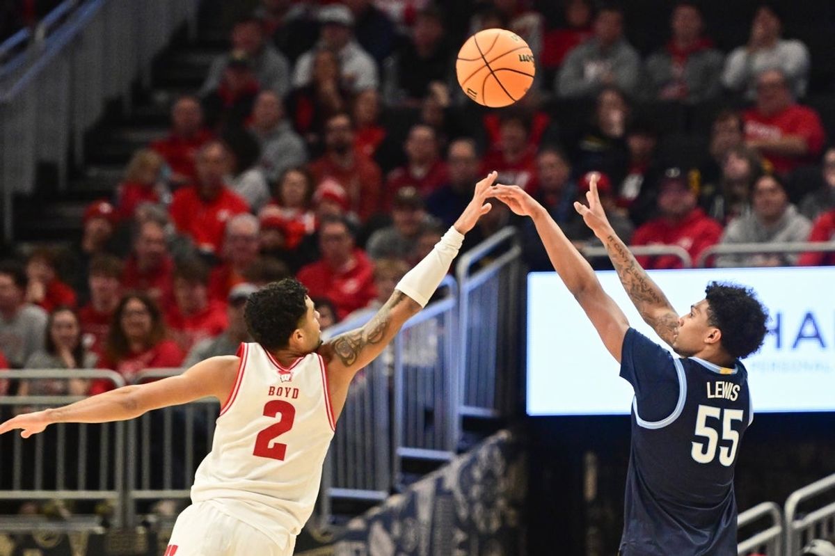 Dec 19, 2025; Milwaukee, Wisconsin, USA;  Villanova Wildcats guard Acaden Lewis (55) shoot s three-point shot against Wisconsin Badgers guard Nick Boyd (2) first half at the Fiserv Forum. Mandatory Credit: Benny Sieu-Imagn Images