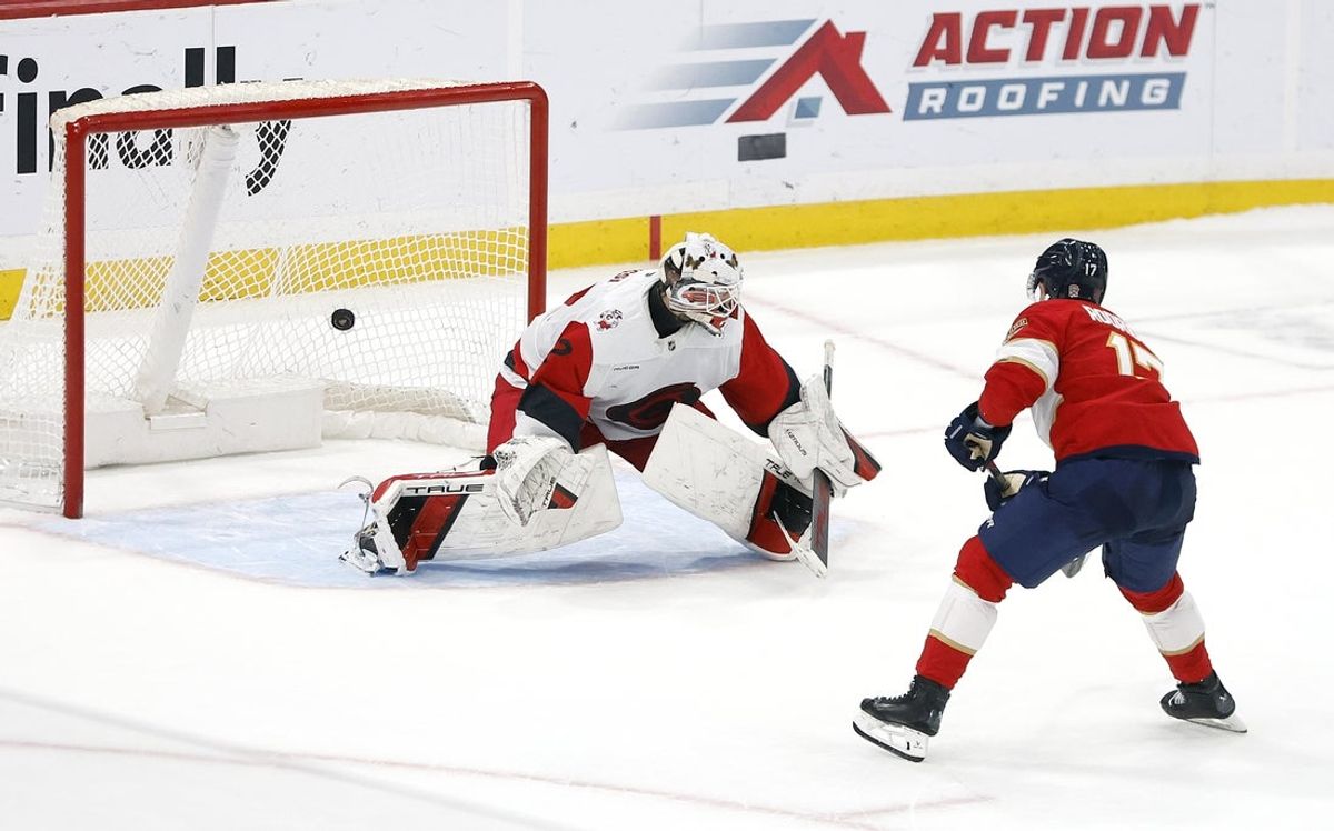 Dec 19, 2025; Sunrise, Florida, USA;  Florida Panthers center Evan Rodrigues (17) scores against Carolina Hurricanes goaltender Brandon Bussi (32) during the shootout at Amerant Bank Arena. Mandatory Credit: Rhona Wise-Imagn Images