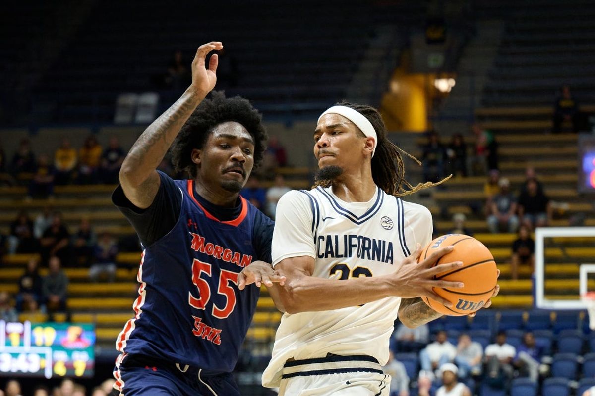 Dec 19, 2025; Berkeley, California, USA; California Golden Bears forward Chris Bell (22) drives with the ball against Morgan State Bears forward Eugene Alvin (55) during the first half at Haas Pavilion. Mandatory Credit: Robert Edwards-Imagn Images