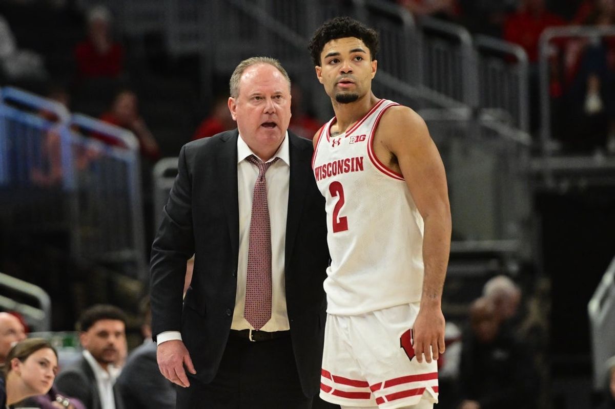 Dec 19, 2025; Milwaukee, Wisconsin, USA; Wisconsin Badgers head coach Greg Gard talks to guard Nick Boyd (2) in overtime against the Villanova Wildcats at the Fiserv Forum. Mandatory Credit: Benny Sieu-Imagn Images