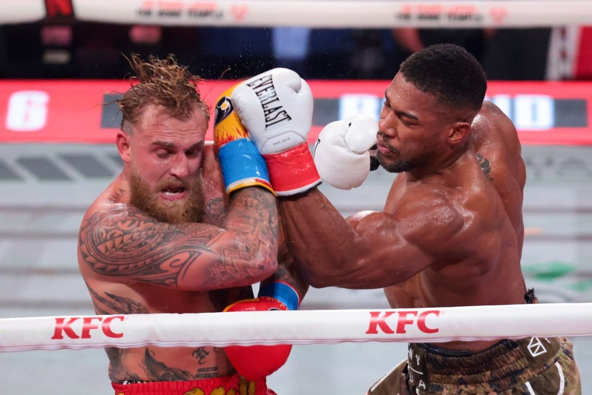 Dec 19, 2025; Miami, Florida, UNITED STATES; Anthony Joshua hits Jake Paul during a heavyweight boxing bout at Kayesa Center. Mandatory Credit: Sam Navarro-Imagn Images