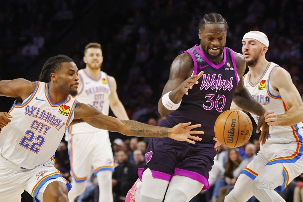 Dec 19, 2025; Minneapolis, Minnesota, USA; Oklahoma City Thunder guard Cason Wallace (22) knocks the ball from Minnesota Timberwolves forward Julius Randle (30) in the third quarter at Target Center. Mandatory Credit: Bruce Kluckhohn-Imagn Images