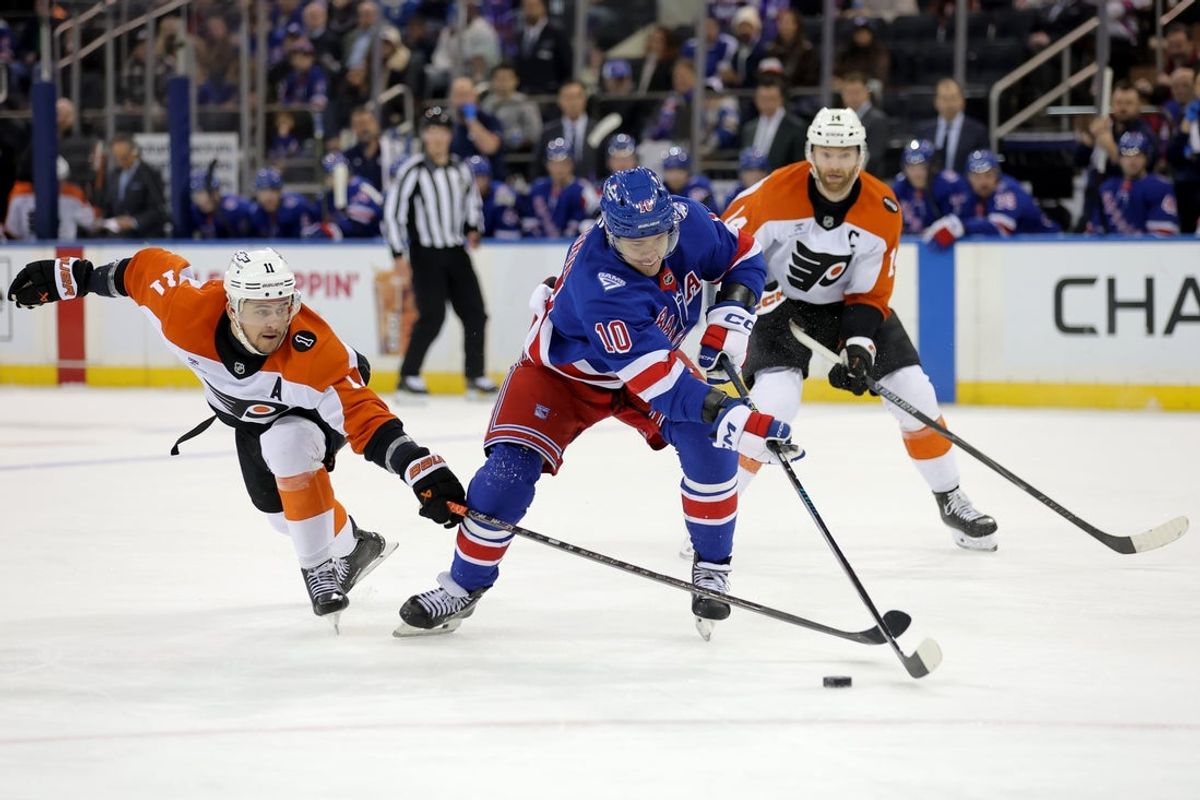 Dec 20, 2025; New York, New York, USA; New York Rangers left wing Artemi Panarin (10) skates with the puck against Philadelphia Flyers right wing Travis Konecny (11) and center Sean Couturier (14) during the second period at Madison Square Garden. Mandatory Credit: Brad Penner-Imagn Images