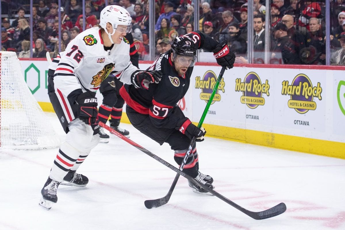 Dec 20, 2025; Ottawa, Ontario, CAN; Chicago Blackhawks defenseman Alex Vlasic (72 and Ottawa Senators left wing David Perron (57) jockey for position in the first period at the Canadian Tire Centre. Mandatory Credit: Marc DesRosiers-IMAGN Images