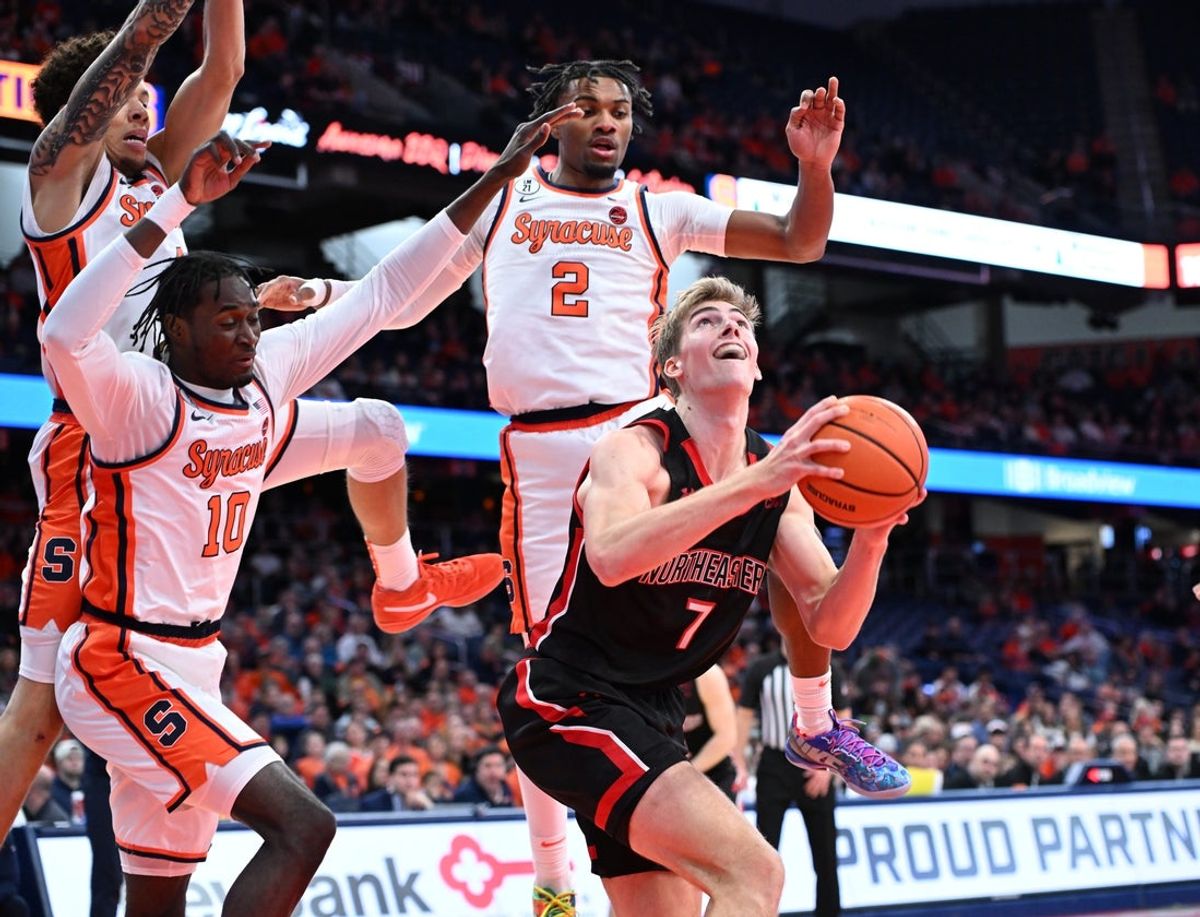 Dec 20, 2025; Syracuse, New York, USA; Northeastern Huskies forward Youri Fritz (7)draws the defense of Syracuse Orange guard JJ Starling (2) with forward Ibrahim Souare (10) and guard Nate Kingz (4) in the first half at the JMA Wireless Dome. Mandatory Credit: Mark Konezny-Imagn Images