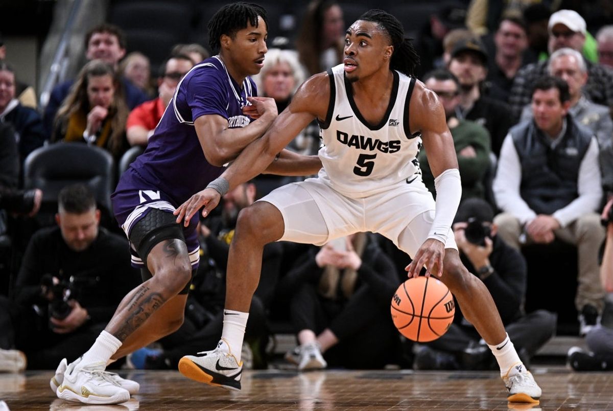 Dec 20, 2025; Indianapolis, Indiana, USA; Butler Bulldogs forward Michael Ajayi (5) goes to the basket against Northwestern Wildcats guard Justin Mullins (20) during the first half at Gainbridge Fieldhouse. Mandatory Credit: Robert Goddin-Imagn Images