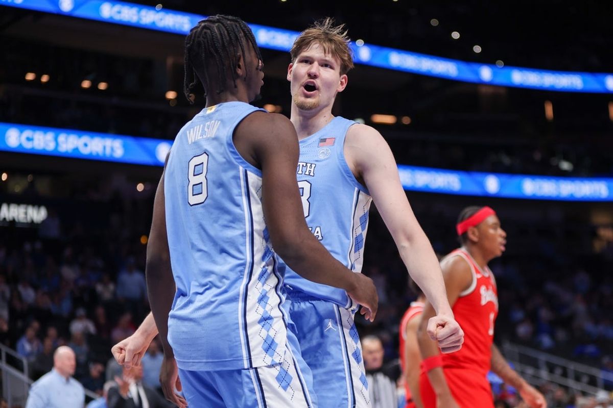 Dec 20, 2025; Atlanta, Georgia, USA; North Carolina Tar Heels forward Caleb Wilson (8) and center Henri Veesaar (13) celebrate after a basket against the Ohio State Buckeyes in the second half at State Farm Arena. Mandatory Credit: Brett Davis-Imagn Images