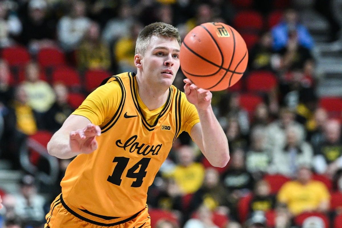 Dec 20, 2025; Iowa City, Iowa, USA; Iowa Hawkeyes guard Bennett Stirtz (14) controls the ball against the Bucknell Bison during the first half at Casey’s Center. Mandatory Credit: Jeffrey Becker-Imagn Images