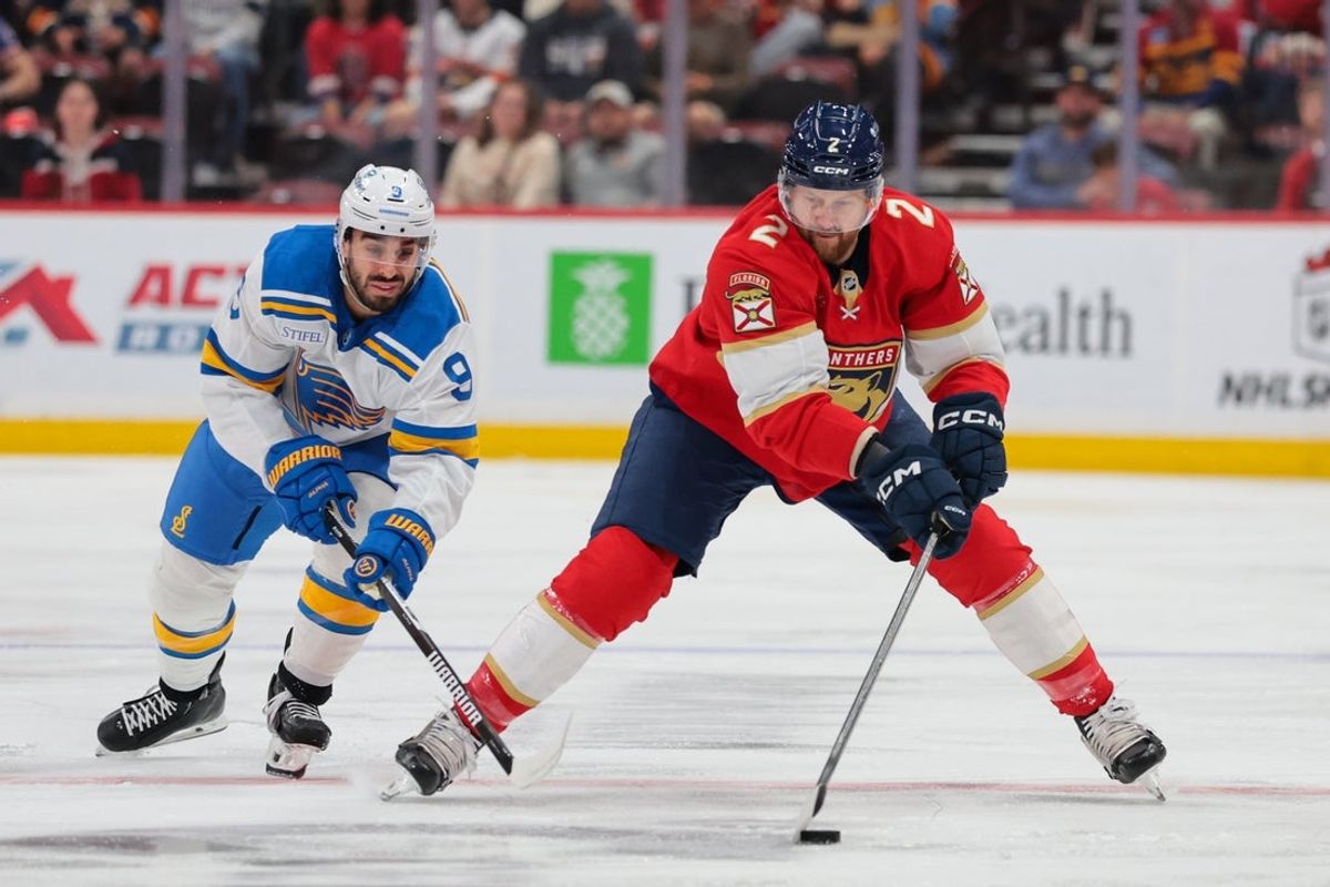 Dec 20, 2025; Sunrise, Florida, USA; Florida Panthers defenseman Jeff Petry (2) moves the puck against St. Louis Blues center Robby Fabbri (9) during the first period at Amerant Bank Arena. Mandatory Credit: Sam Navarro-Imagn Images