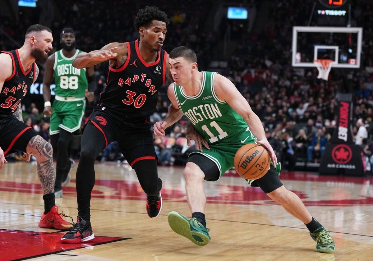 Dec 20, 2025; Toronto, Ontario, CAN; Boston Celtics guard Payton Pritchard (11) controls the ball as Toronto Raptors guard Ochai Agbaji (30) tries to defend during the first quarter at Scotiabank Arena. Mandatory Credit: Nick Turchiaro-Imagn Images