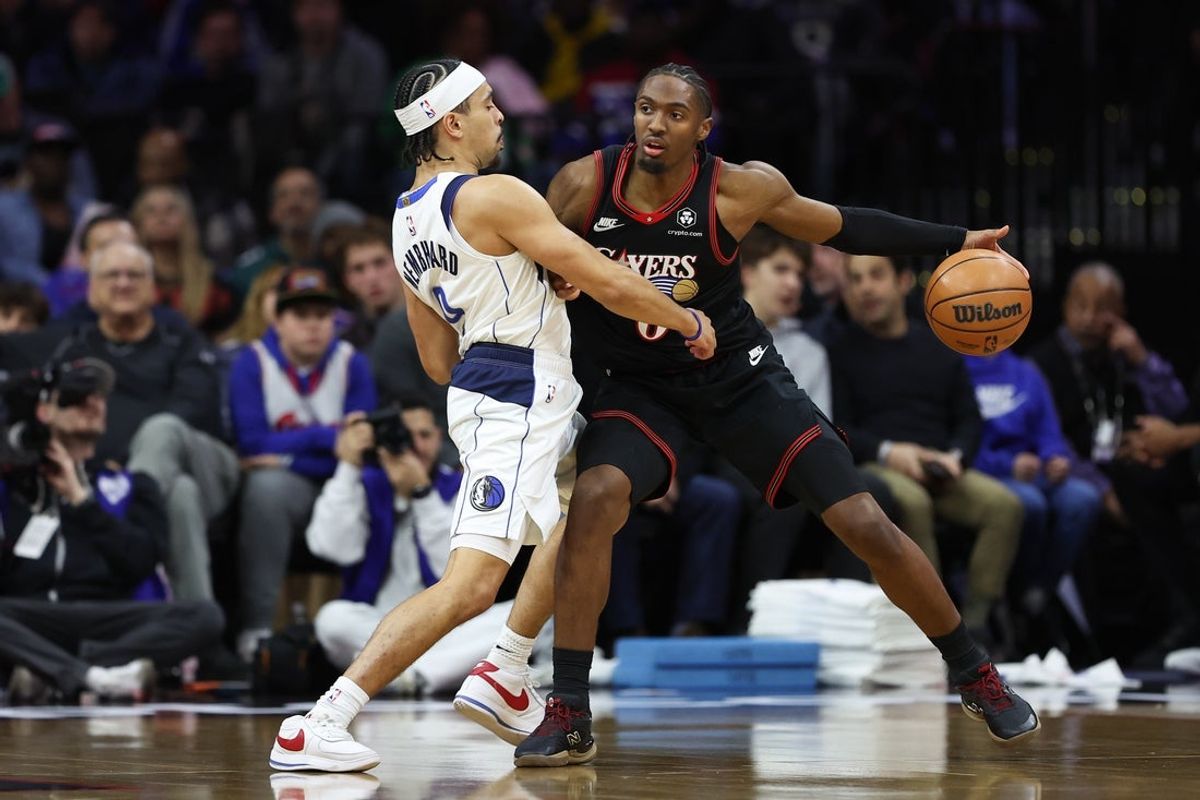 Dec 20, 2025; Philadelphia, Pennsylvania, USA; Philadelphia 76ers guard Tyrese Maxey (0) controls the ball against Dallas Mavericks guard Ryan Nembhard (9) during the first quarter at Xfinity Mobile Arena. Mandatory Credit: Bill Streicher-Imagn Images