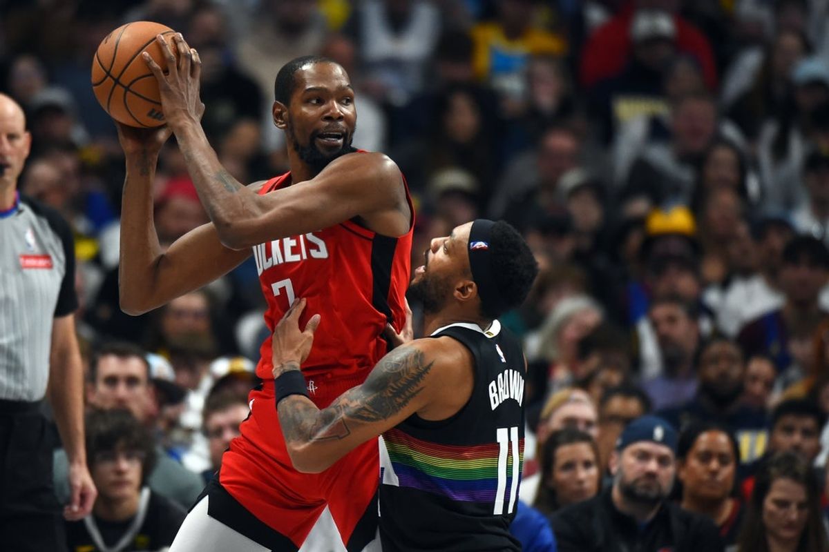 Dec 20, 2025; Denver, Colorado, USA; Houston Rockets forward Kevin Durant (7) holds the ball as he is defended by Denver Nuggets guard Bruce Brown (11) during the second half at Ball Arena. Mandatory Credit: Christopher Hanewinckel-Imagn Images
