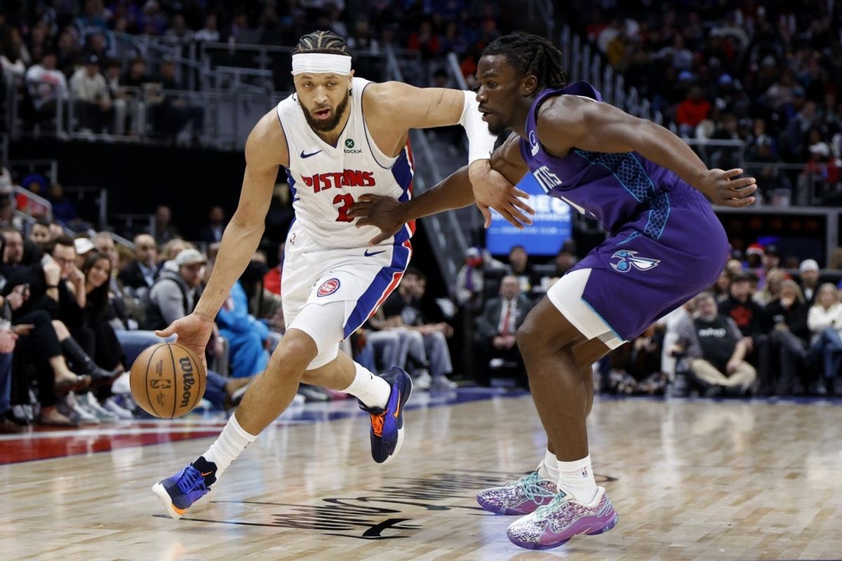 Dec 20, 2025; Detroit, Michigan, USA;  Detroit Pistons guard Cade Cunningham (2) dribbles defended by Charlotte Hornets guard Sion James (4) in the first half at Little Caesars Arena. Mandatory Credit: Rick Osentoski-Imagn Images