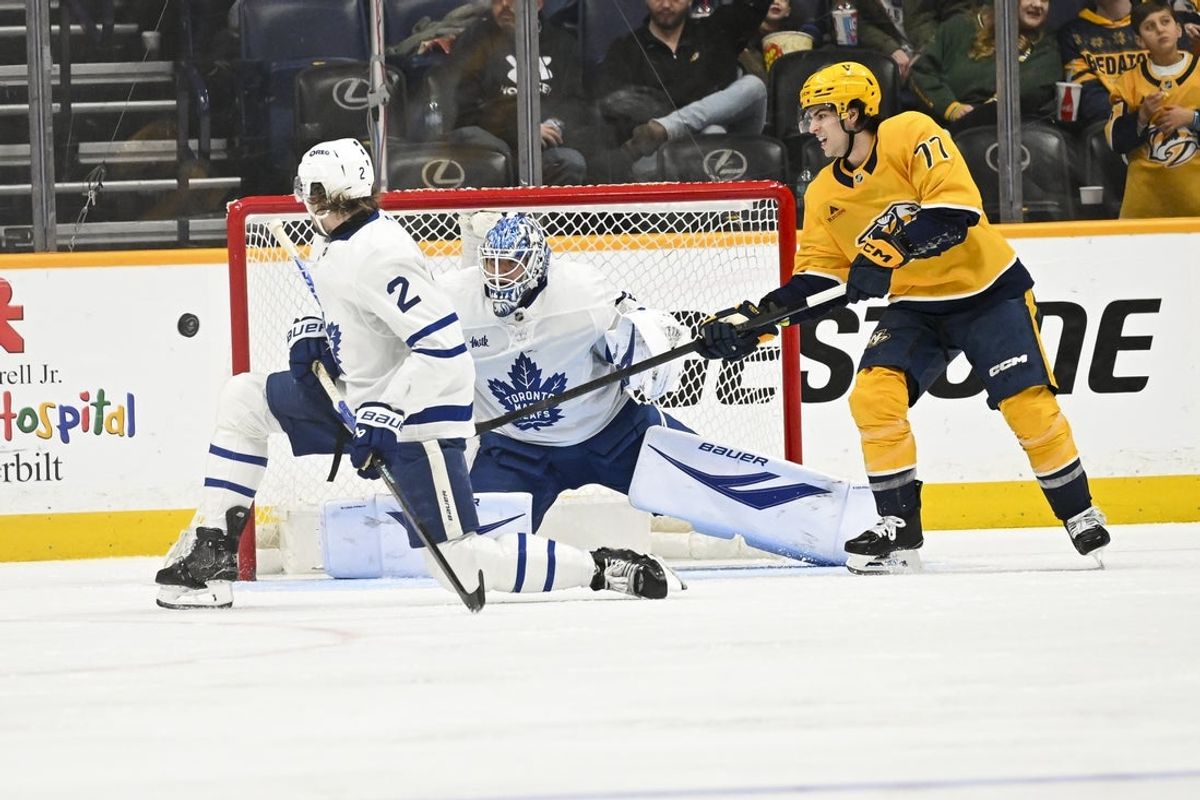 Dec 20, 2025; Nashville, Tennessee, USA;  Toronto Maple Leafs goaltender Joseph Woll (60) blocks the shot of Nashville Predators right wing Luke Evangelista (77) during the second period at Bridgestone Arena. Mandatory Credit: Steve Roberts-Imagn Images