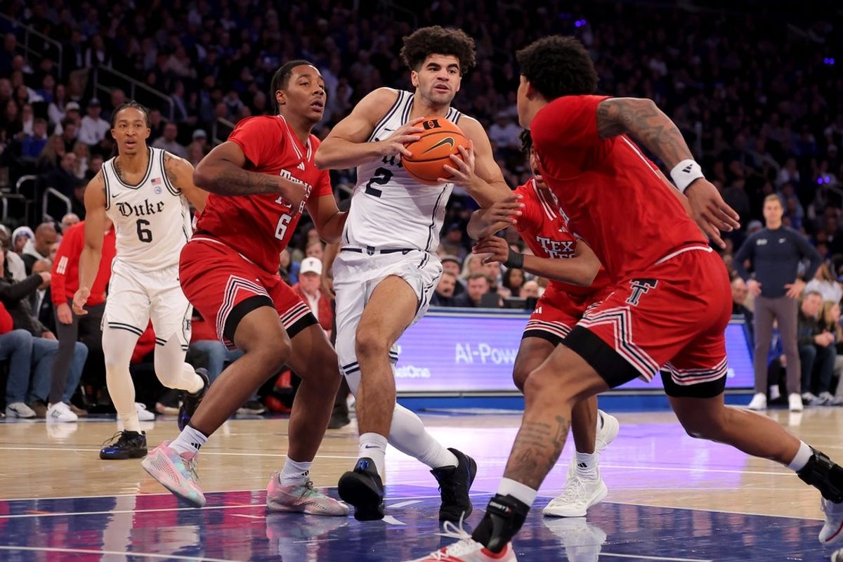 Dec 20, 2025; New York, New York, USA; Duke Blue Devils guard Cayden Boozer (2) drives to the basket against Texas Tech Red Raiders guards Leon Horner (6) and Christian Anderson (4) and forward Lejuan Watts (3) during the first half at Madison Square Garden. Mandatory Credit: Brad Penner-Imagn Images