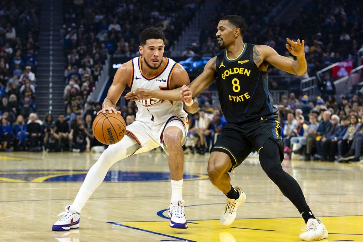 Dec 20, 2025; San Francisco, California, USA; Golden State Warriors guard De'Anthony Melton (8) defends Phoenix Suns guard Devin Booker (1) during the first quarter at Chase Center. Mandatory Credit: John Hefti-Imagn Images