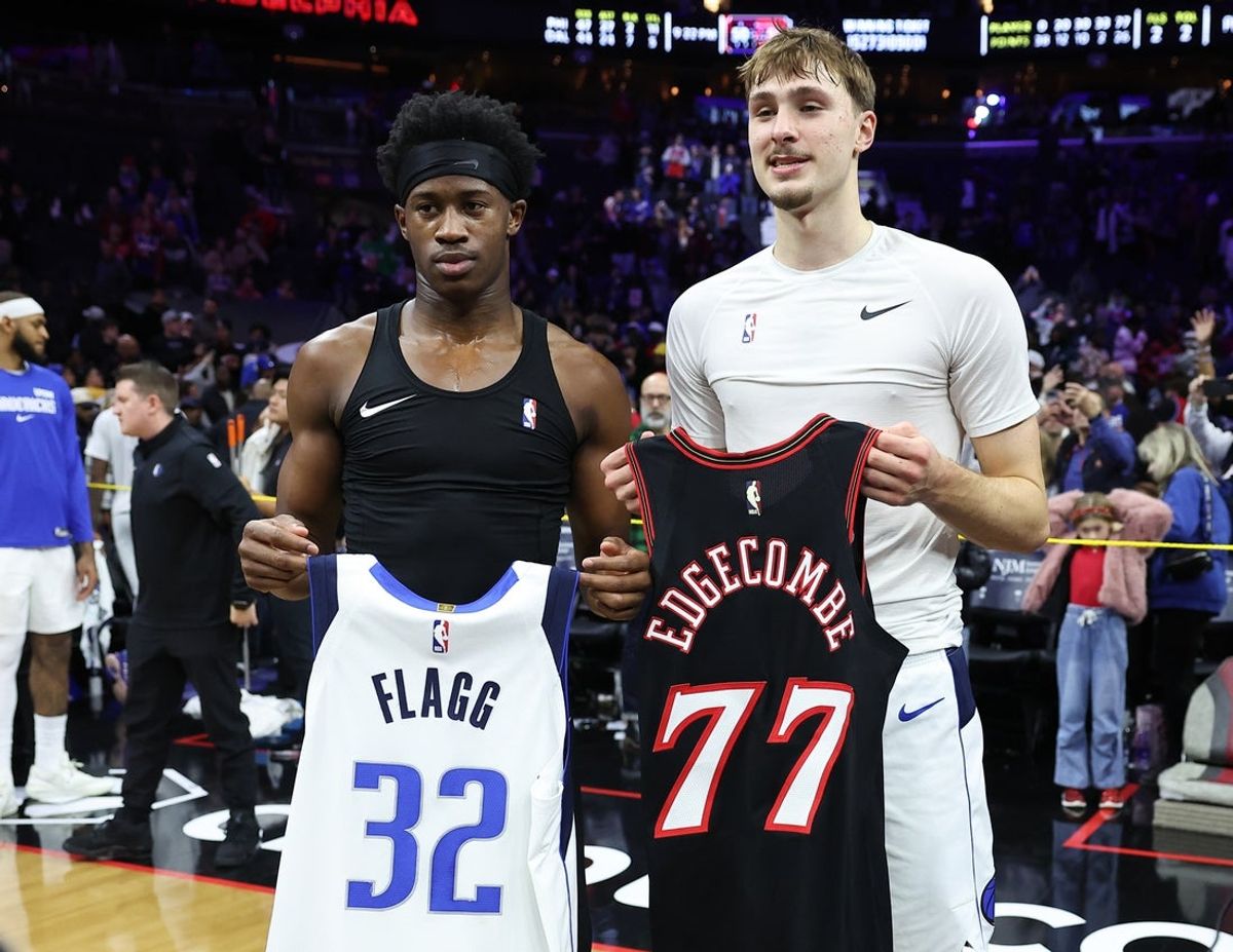 Dec 20, 2025; Philadelphia, Pennsylvania, USA; Philadelphia 76ers guard Vj Edgecombe (L) and Dallas Mavericks forward Cooper Flagg (R) swap jerseys after the game at Xfinity Mobile Arena. Mandatory Credit: Bill Streicher-Imagn Images