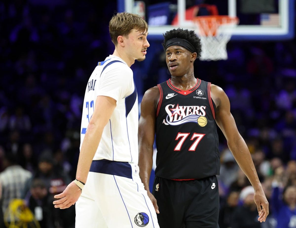 Dec 20, 2025; Philadelphia, Pennsylvania, USA; Philadelphia 76ers guard Vj Edgecombe (77) reacts with Dallas Mavericks forward Cooper Flagg (32) during the fourth quarter at Xfinity Mobile Arena. Mandatory Credit: Bill Streicher-Imagn Images