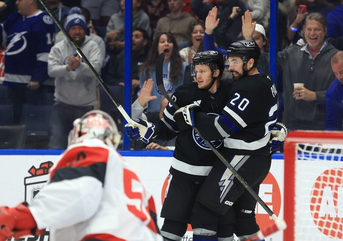 Dec 18, 2025; Tampa, Florida, USA; Tampa Bay Lightning center Jake Guentzel (59) is congratulated after he scored a goal against the Carolina Hurricanes during the third period at Benchmark International Arena. Mandatory Credit: Kim Klement Neitzel-Imagn Images