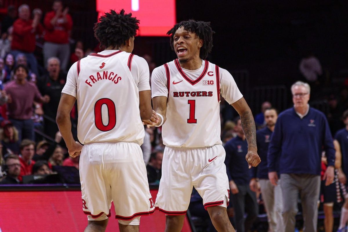 Dec 20, 2025; Piscataway, New Jersey, USA; Rutgers Scarlet Knights guard Tariq Francis (0) and guard Jamichael Davis (1) celebrates after a basket against the Penn Quakers during the second half at Jersey Mike's Arena. Mandatory Credit: Vincent Carchietta-Imagn Images