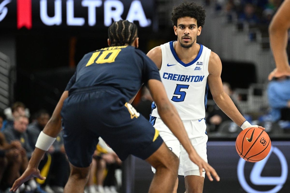 Dec 20, 2025; Omaha, Nebraska, USA;  Creighton Bluejays guard Nik Graves (5) dribbles againsta Marquette Golden Eagles guard Adrien Stevens (10) during the second half at CHI Health Center Omaha. Mandatory Credit: Steven Branscombe-Imagn Images