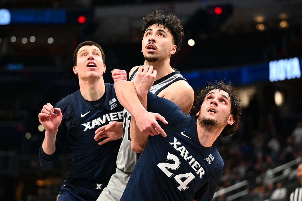 Dec 20, 2025; Washington, District of Columbia, USA; Xavier Musketeers forward Jovan Milicevic (24) and Georgetown Hoyas center Julius Halaifonua (11) and Xavier Musketeers forward Filip Borovicanin (4) box out during the second half at Capital One Arena. Mandatory Credit: Brad Mills-Imagn Images