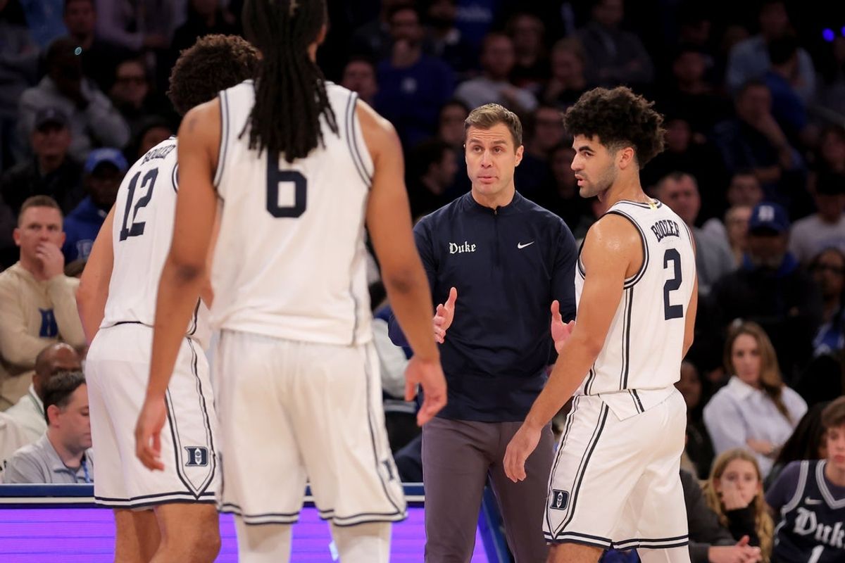 Dec 20, 2025; New York, New York, USA; Duke Blue Devils head coach Jon Scheyer talks to Duke Blue Devils forwards Cameron Boozer (12) and Maliq Brown (6) and guard Cayden Boozer (2) during the second half against the Texas Tech Red Raiders at Madison Square Garden. Mandatory Credit: Brad Penner-Imagn Images