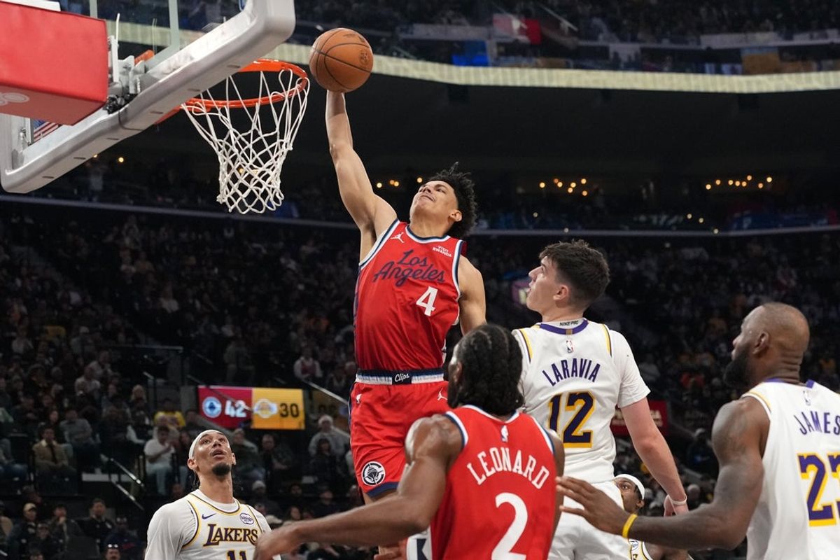 Dec 20, 2025; Inglewood, California, USA; LA Clippers guard Kobe Sanders (4) dunks the ball against the Los Angeles Lakers in the first half at Intuit Dome. Mandatory Credit: Kirby Lee-Imagn Images
