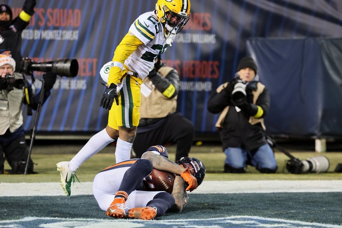 Dec 20, 2025; Chicago, Illinois, USA; Chicago Bears wide receiver DJ Moore (2) catches the game-winning forty-six yard touchdown pass thrown by quarterback Caleb Williams (not pictured) in overtime against Green Bay Packers cornerback Keisean Nixon (25) at Soldier Field. Mandatory Credit: Mike Dinovo-Imagn Images
