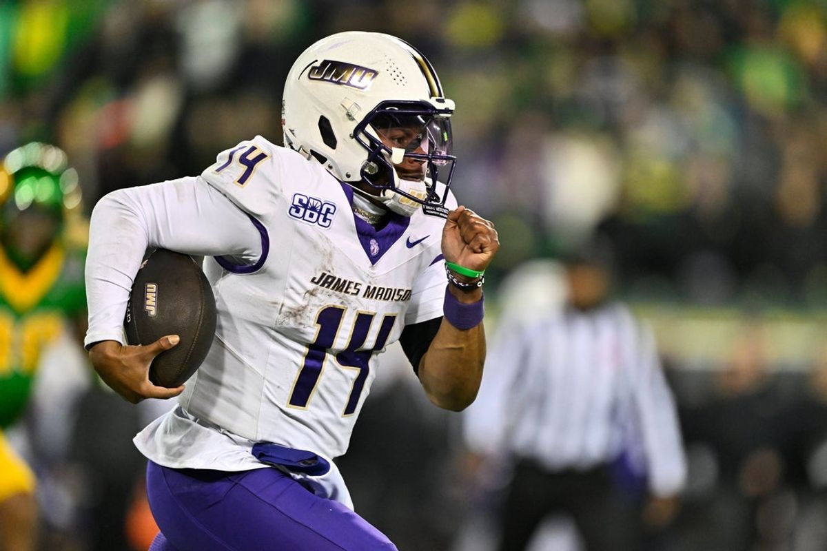 Dec 20, 2025; Eugene, OR, USA;  James Madison Dukes quarterback Alonza Barnett III (14) rushes during the fourth quarter against the Oregon Ducks at Autzen Stadium. Mandatory Credit: Craig Strobeck-Imagn Images
