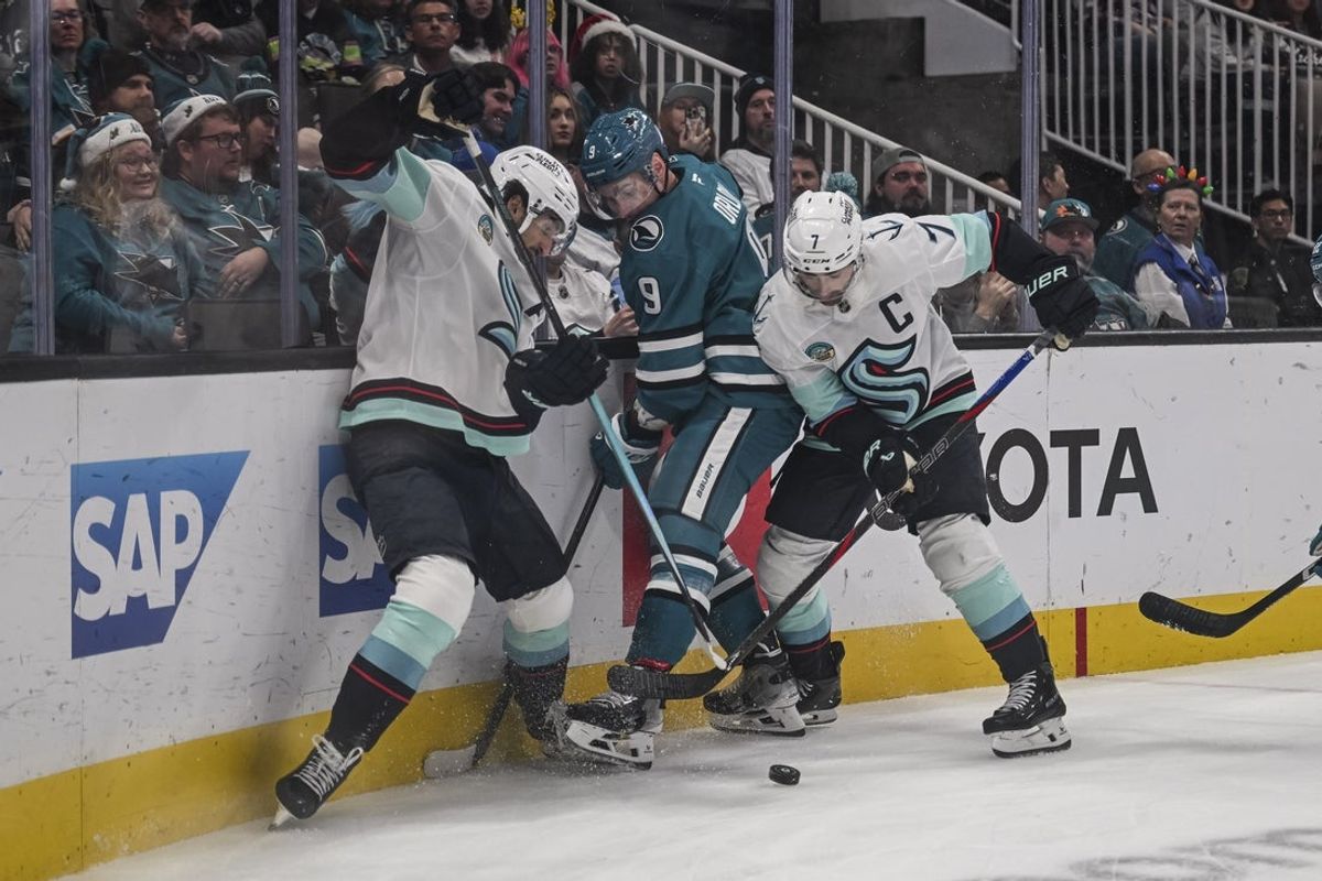 Dec 20, 2025; San Jose, California, USA; San Jose Sharks defenseman Dmitry Orlov (9) and Seattle Kraken right wing Jordan Eberle (7) fight for control of the puck during the second period at SAP Center at San Jose. Mandatory Credit: Justine Willard-Imagn Images