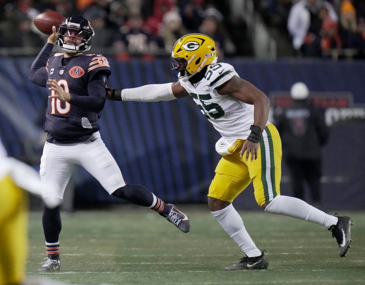 Chicago Bears quarterback Caleb Williams (18) is pressured by Green Bay Packers defensive end Kingsley Enagbare (55) during the first quarter of their game Saturday, December 20, 2025 at Soldier Field in Chicago, Illinois.