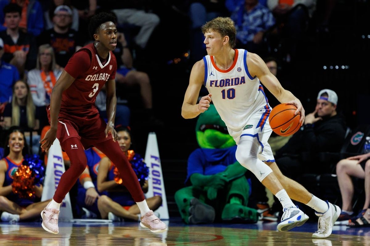 Dec 21, 2025; Gainesville, Florida, USA; Florida Gators forward Thomas Haugh (10) dribbles the ball while Colgate Raiders guard Jalen Cox (3) defends during the first half at Exactech Arena at the Stephen C. O'Connell Center. Mandatory Credit: Matt Pendleton-Imagn Images