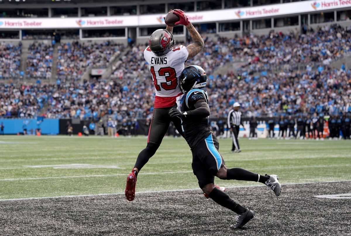 Dec 21, 2025; Charlotte, North Carolina, USA; Tampa Bay Buccaneers wide receiver Mike Evans (13) catches a touchdown against Carolina Panthers cornerback Mike Jackson (2) during the first half at Bank of America Stadium. Mandatory Credit: Jim Dedmon-Imagn Images