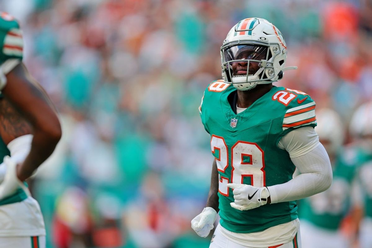 Dec 21, 2025; Miami Gardens, Florida, USA; Miami Dolphins running back De'Von Achane (28) reacts after scoring a touchdown during the first quarter against the Cincinnati Bengals at Hard Rock Stadium. Mandatory Credit: Sam Navarro-Imagn Images
