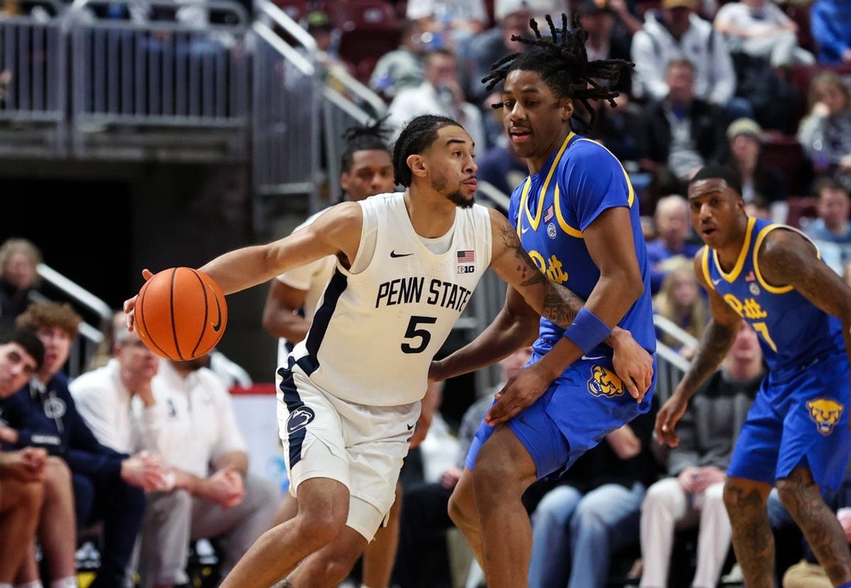 Dec 21, 2025; Hershey, Pennsylvania, USA; Penn State Nittany Lions guard Freddie Dilione V (5) drives the ball around Pittsburgh Panthers guard Omari Witherspoon (8) during the second half at Giant Center. Mandatory Credit: Matthew O'Haren-Imagn Images
