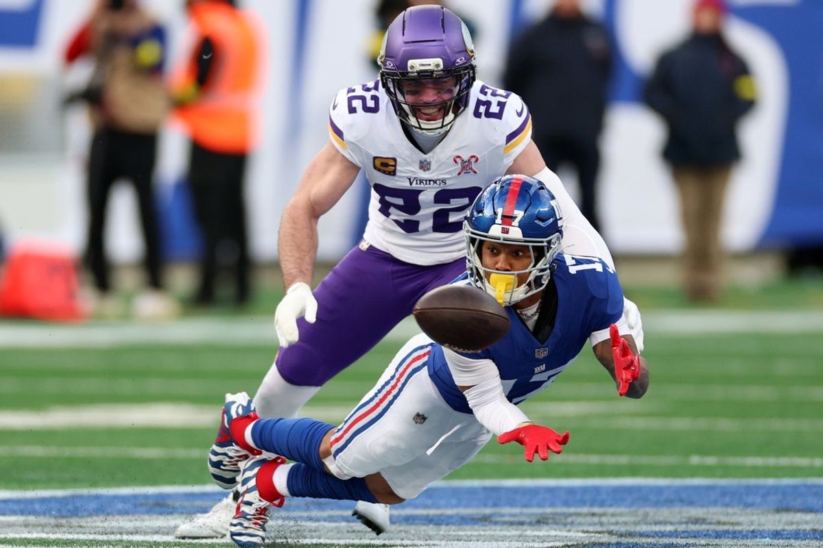 Dec 21, 2025; East Rutherford, New Jersey, USA; New York Giants wide receiver Wan'Dale Robinson (17) makes a catch against Minnesota Vikings free safety Harrison Smith (22) during the second half at MetLife Stadium. Mandatory Credit: Vincent Carchietta-Imagn Images