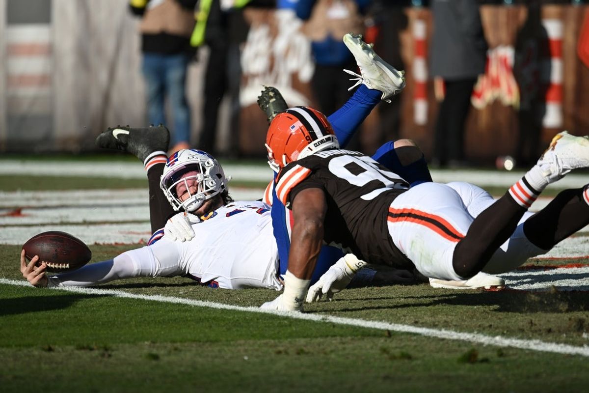 Dec 21, 2025; Cleveland, Ohio, USA;  Buffalo Bills quarterback Josh Allen (17) is sacked by Cleveland Browns defensive tackle Mason Graham (94) and defensive end Myles Garrett (95) during the first half at Huntington Bank Field. Both Cleveland players were credited with a half of sack on the play. Mandatory Credit: Ken Blaze-Imagn Images