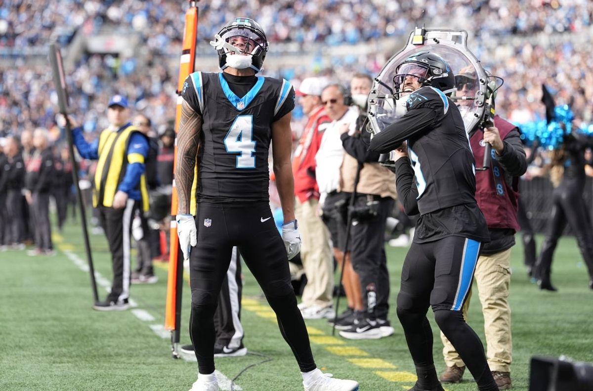 Dec 21, 2025; Charlotte, North Carolina, USA; Carolina Panthers wide receiver Tetairoa McMillan (4) and quarterback Bryce Young (9) celebrate after a play during the second half against the Tampa Bay Buccaneers at Bank of America Stadium. Mandatory Credit: Jim Dedmon-Imagn Images