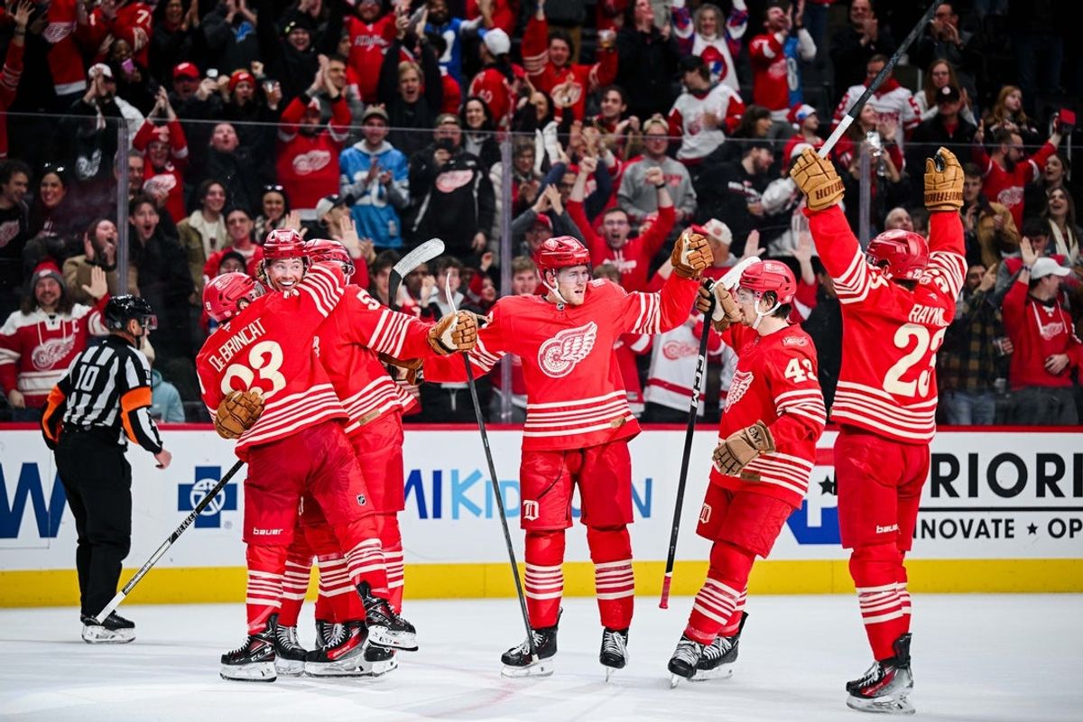 Dec 21, 2025; Detroit, Michigan, USA; Detroit Red Wings defenseman Moritz Seider (53) celebrates his game winning goal with teammates during overtime against the Washington Capitals at Little Caesars Arena. Mandatory Credit: Tim Fuller-Imagn Images