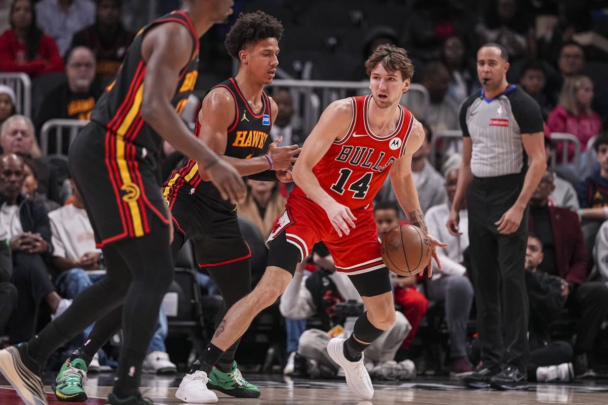 Dec 21, 2025; Atlanta, Georgia, USA; Chicago Bulls forward Matas Buzelis (14) dribbles guarded by Atlanta Hawks forward Jalen Johnson (1) during the first half at State Farm Arena. Mandatory Credit: Dale Zanine-Imagn Images