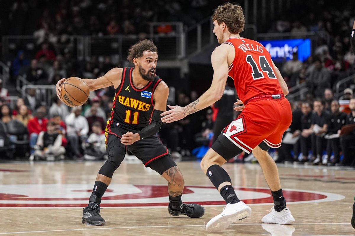 Dec 21, 2025; Atlanta, Georgia, USA; Atlanta Hawks guard Trae Young (11) dribbles against Chicago Bulls forward Matas Buzelis (14) during the first half at State Farm Arena. Mandatory Credit: Dale Zanine-Imagn Images