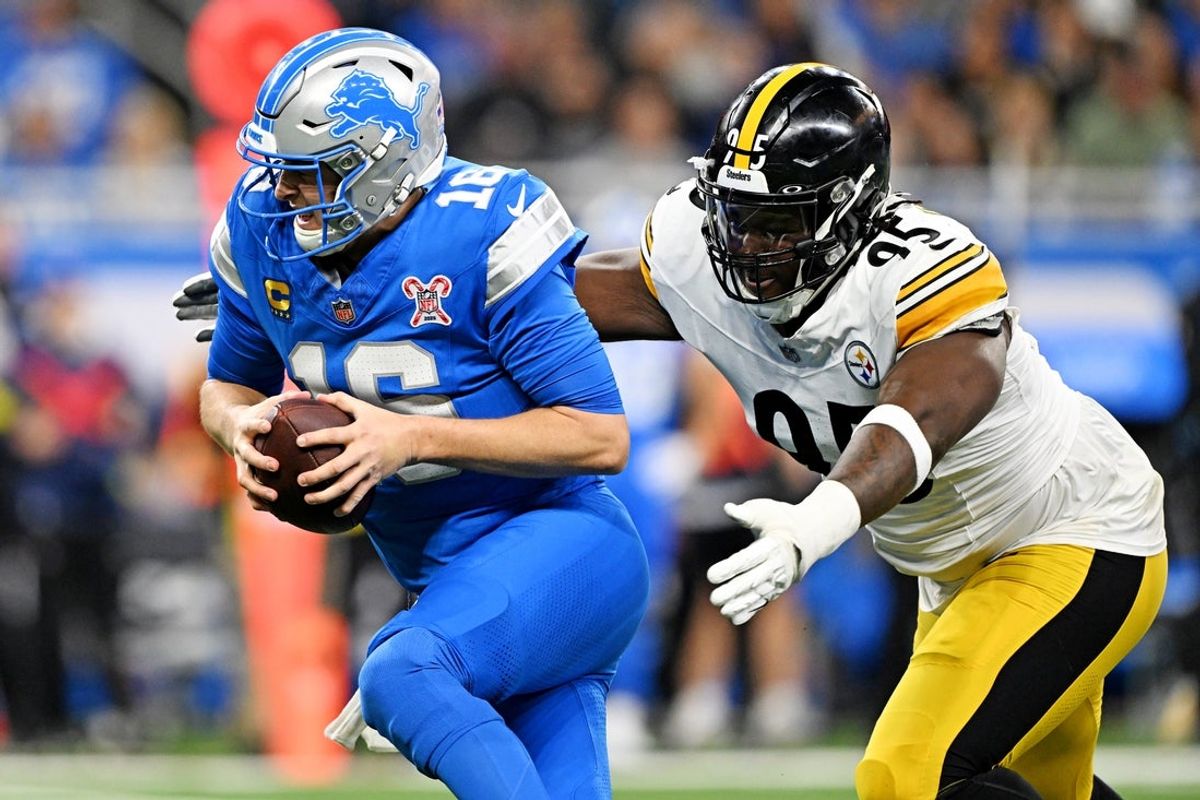 Dec 21, 2025; Detroit, Michigan, USA; Detroit Lions quarterback Jared Goff (16) runs the ball against Pittsburgh Steelers defensive tackle Keeanu Benton (95) during the first quarter at Ford Field. Mandatory Credit: Lon Horwedel-Imagn Images